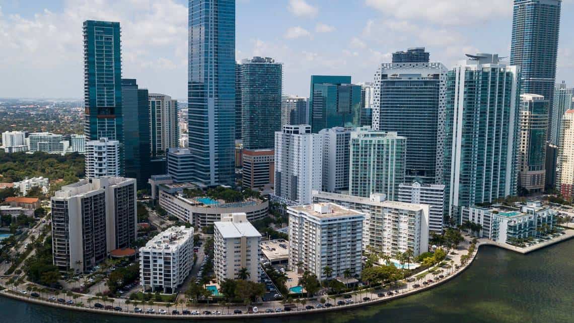 Aerial view of a waterfront urban area with high-rise buildings and residential complexes by the water